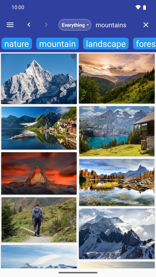 FreePics in English showing mountain photos from Pixabay with subject tags and favorite controls.
